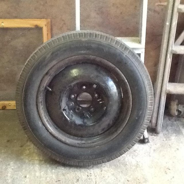 Secondhand wheel and tyre for vintage vehicle.