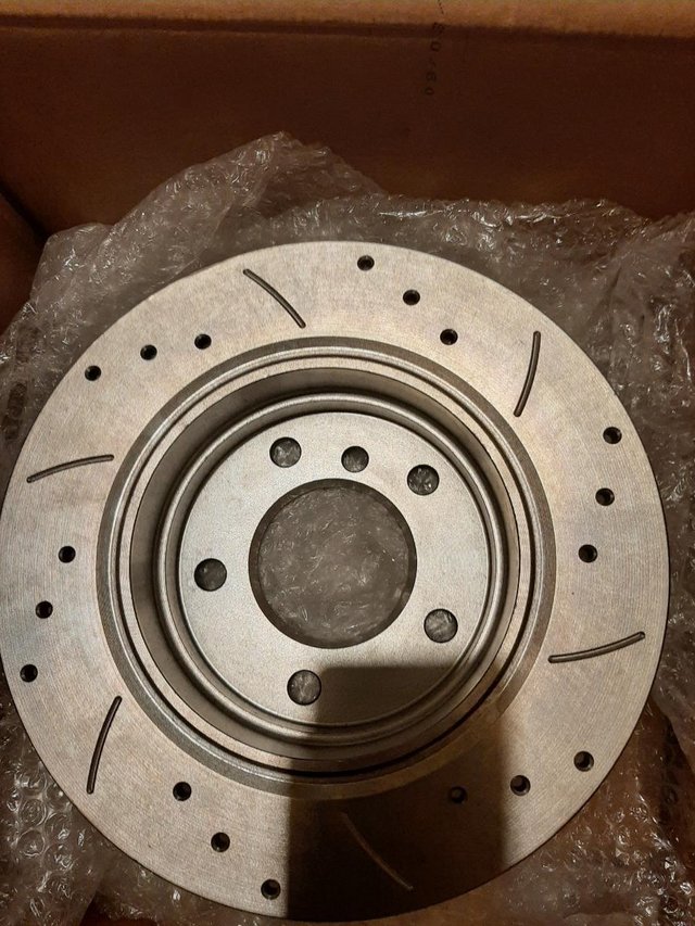 Brake discs, drilled and grooved x 4 and Brake discs x 4 new