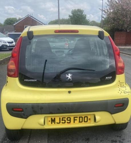 Yellow Peugeot 107 year 