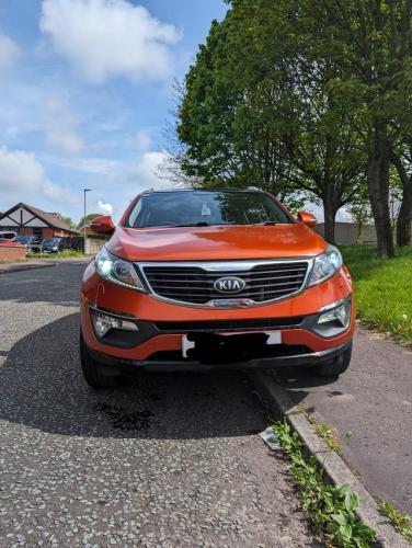 Kia Sportage In burnt orange with black alloys